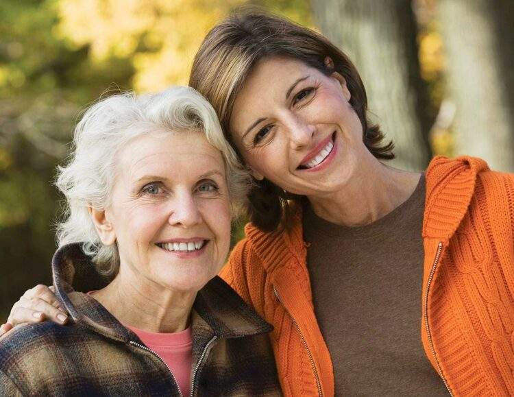 Woman hugs her mother and smiles
